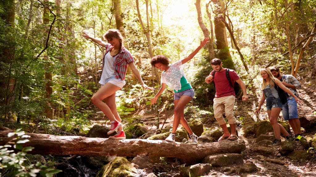 Group of friends enjoying a hike in the woods